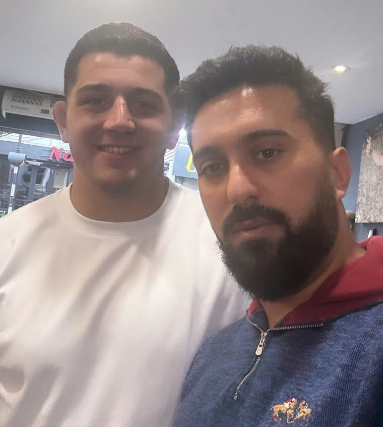 Client and barber, thumbs up after the cut